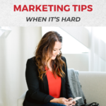 Copy reads: "Pinterest Marketing Tips When It's Hard". A brunette woman sits on a couch looking at her phone.