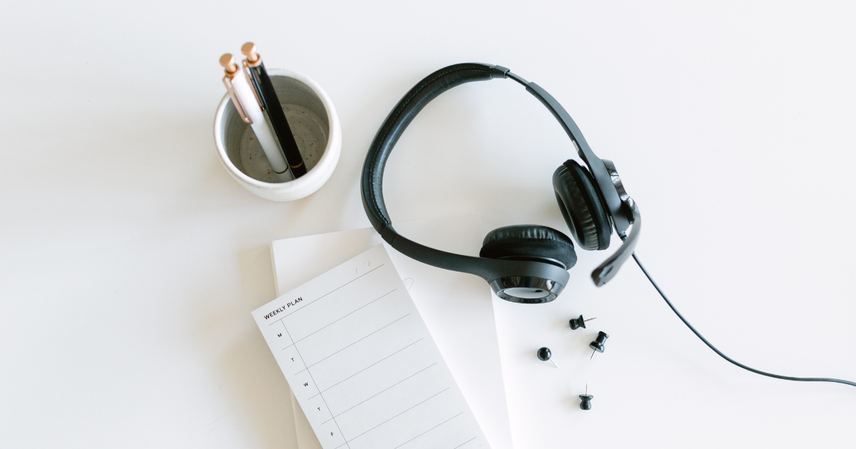 A pair of over-the-ear headphones sit on a counter.