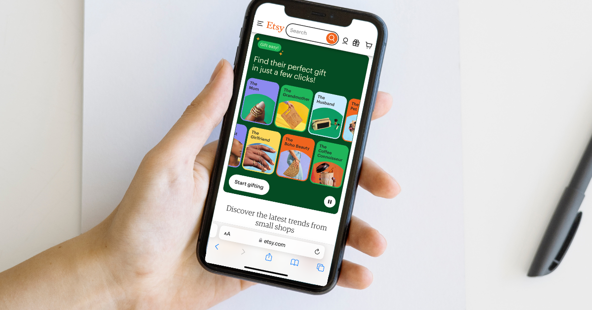 An iPhone is open to Etsy home page.