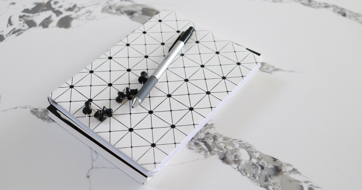 A notebook sitting on a counter.